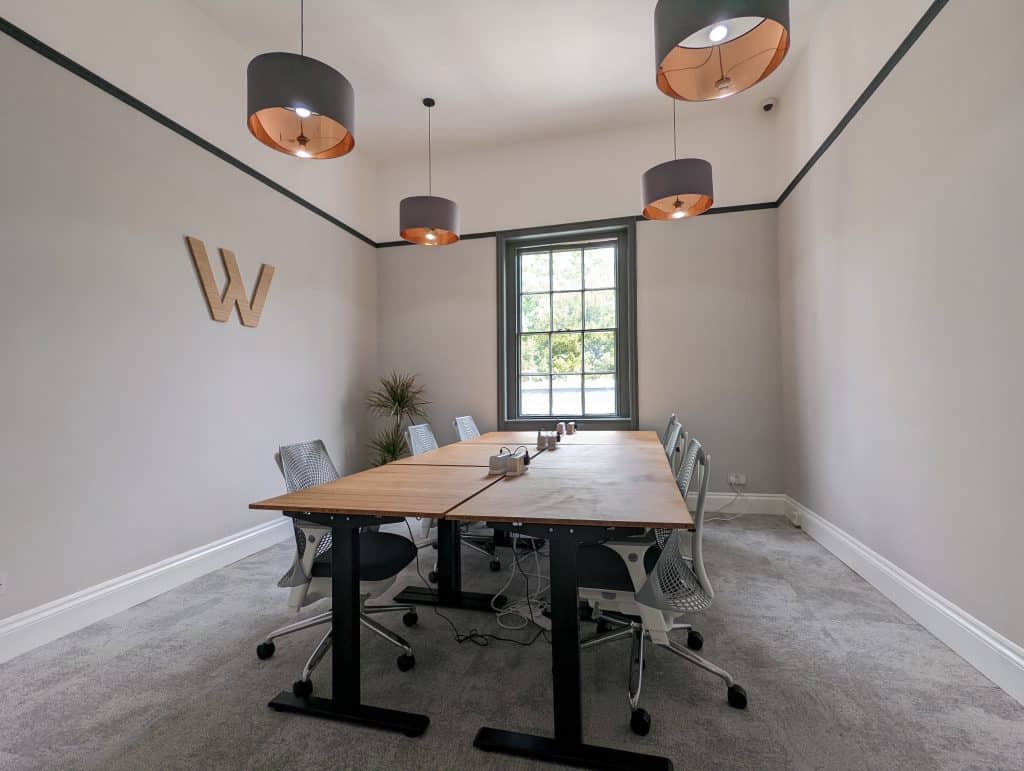 An airy serviced office with bamboo desks, Herman Miller chairs, and plug sockets.
