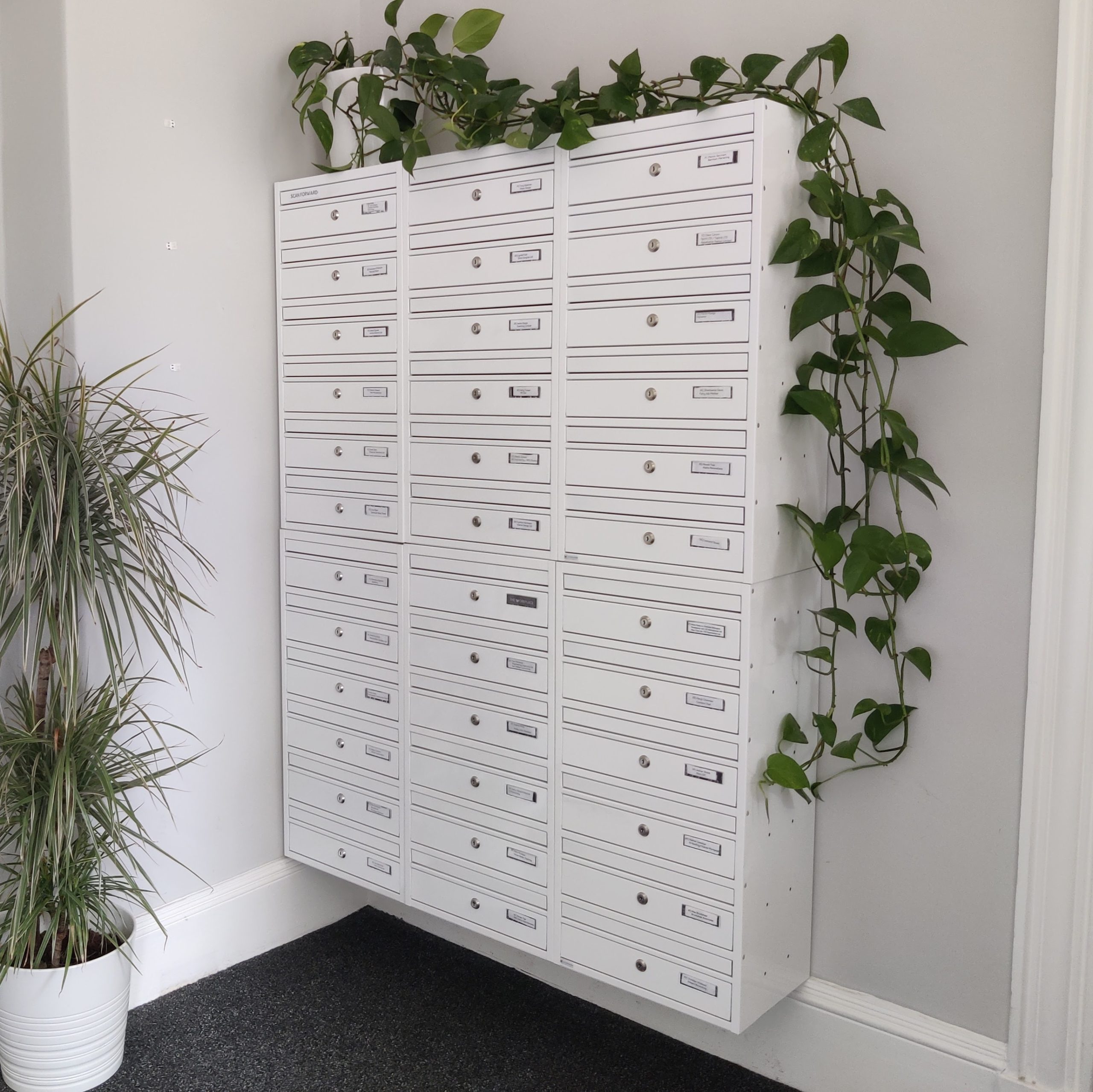 A set of mailboxes in a coworking space, designed for virtual members.